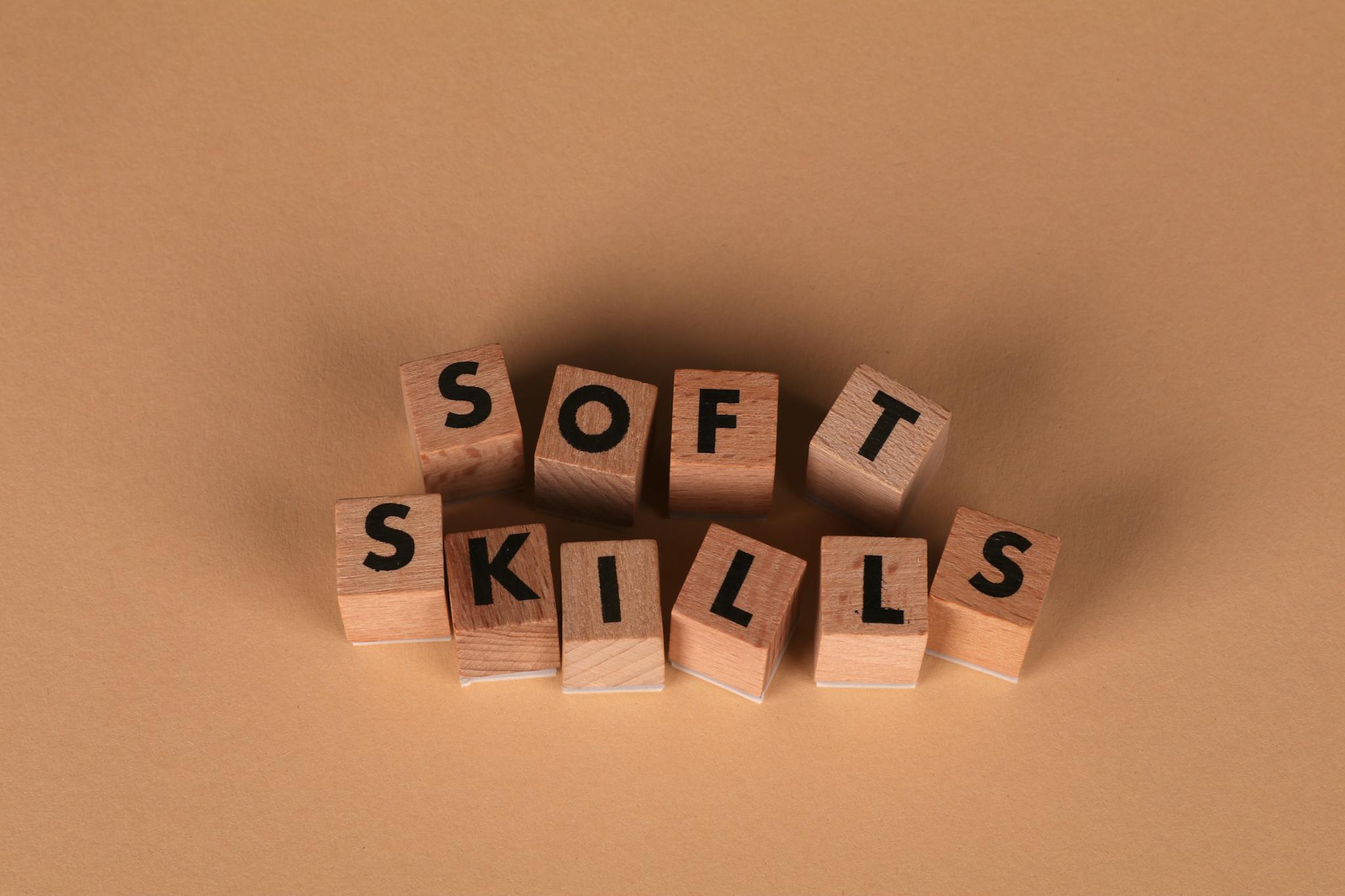 Wooden letter blocks spell out 'Soft Skills', highlighting business and personal development concepts.