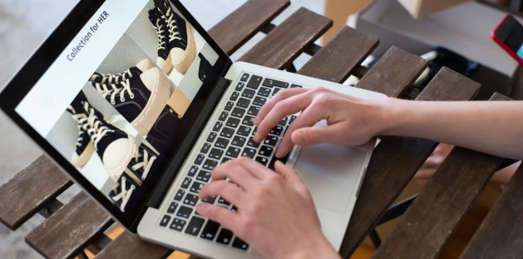 Person typing on laptop managing ecommerce business online in Pakistan