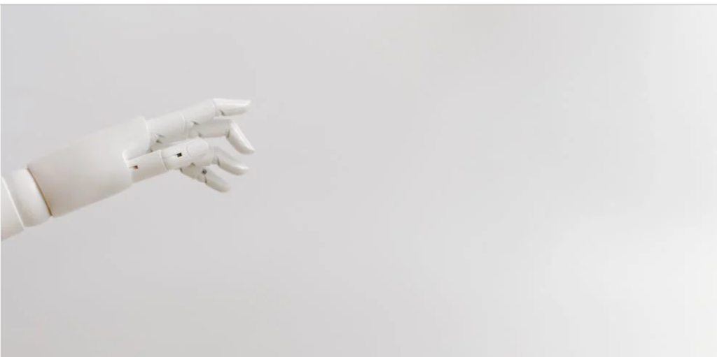 White robotic AI hand representing artificial intelligence courses and technology