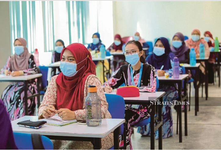 Students wearing face masks sitting in a classroom during an educational session