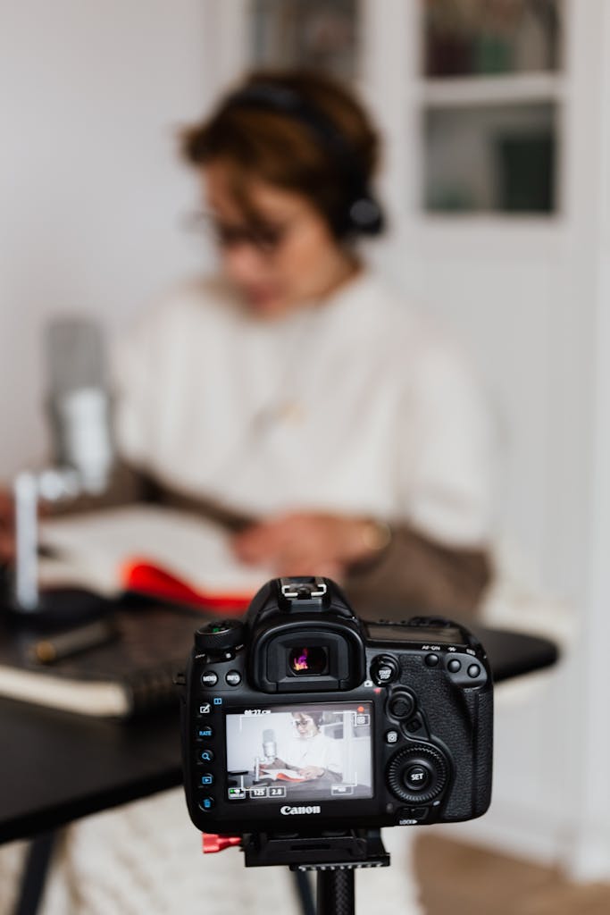 student with headphones reading and journaling for online earning in Pakistan
