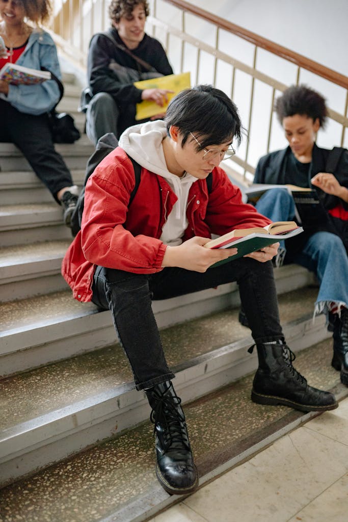 student visa overseas education Pakistan young students reading on university steps