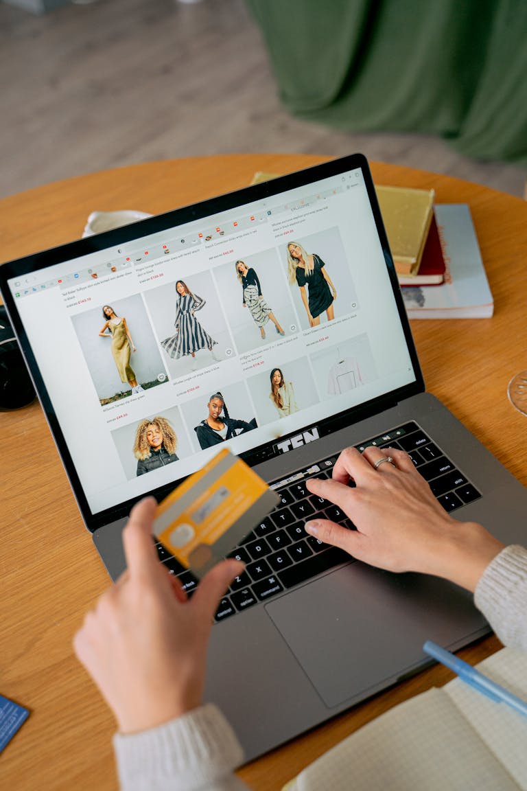 ecommerce in Pakistan woman making online purchase with credit card on laptop browsing fashion store