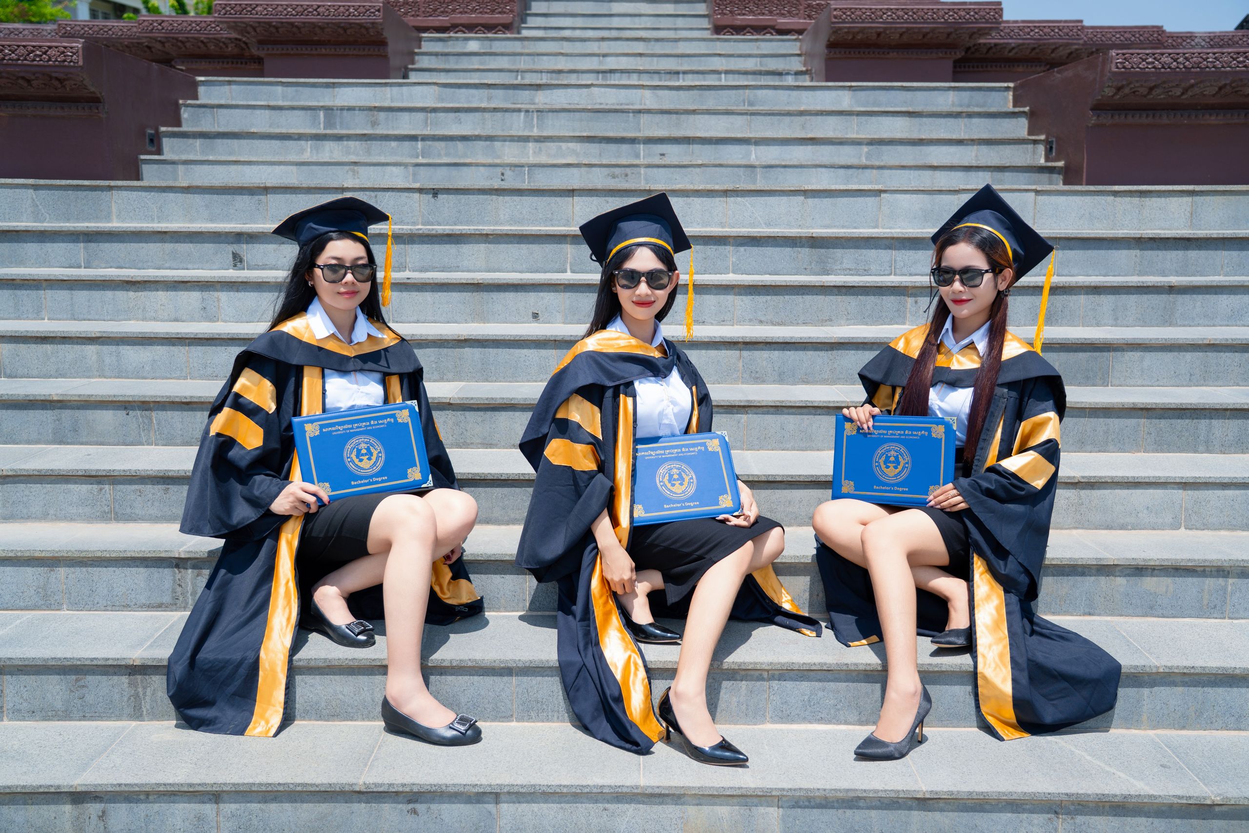 Fresh graduates in caps and gowns celebrating after graduation in Pakistan