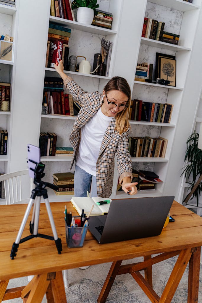 woman teaching online with laptop and smartphone in home library for online earning Pakistan