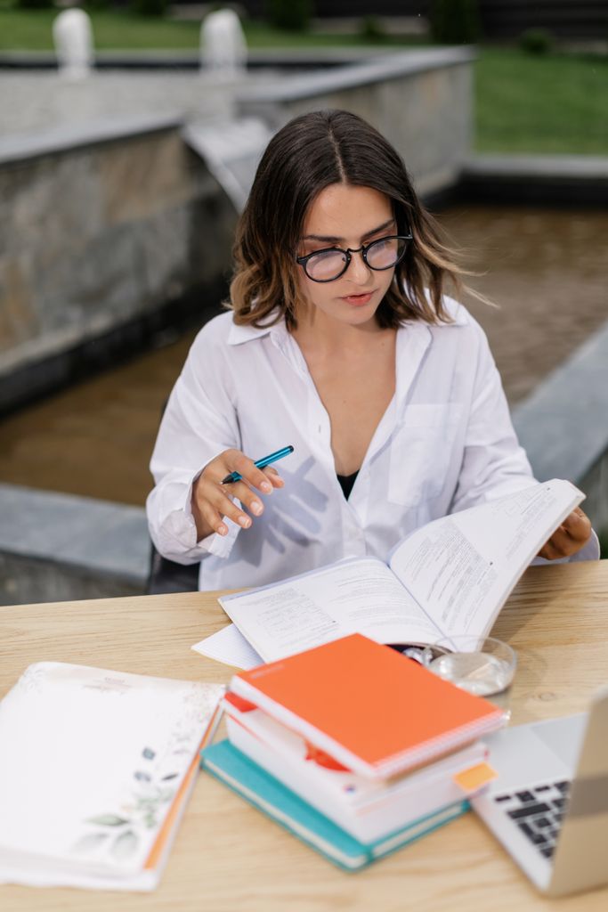 young woman studying outdoors for CSS and PMS exam preparation in Pakistan