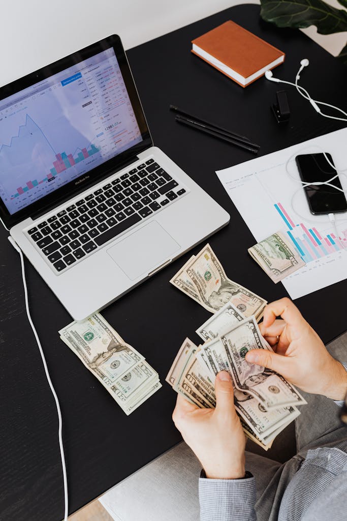 Person using laptop with AI tools to earn money online
